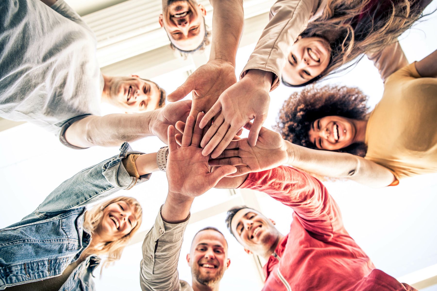 Young happy people stacking hands together outcoor – Community o Personalized Approach To PrTMS